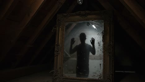 mysterious reflection in an attic: a haunting encounter captured in two frames, revealing the eerie presence of a shadowy figure behind a dusty mirror