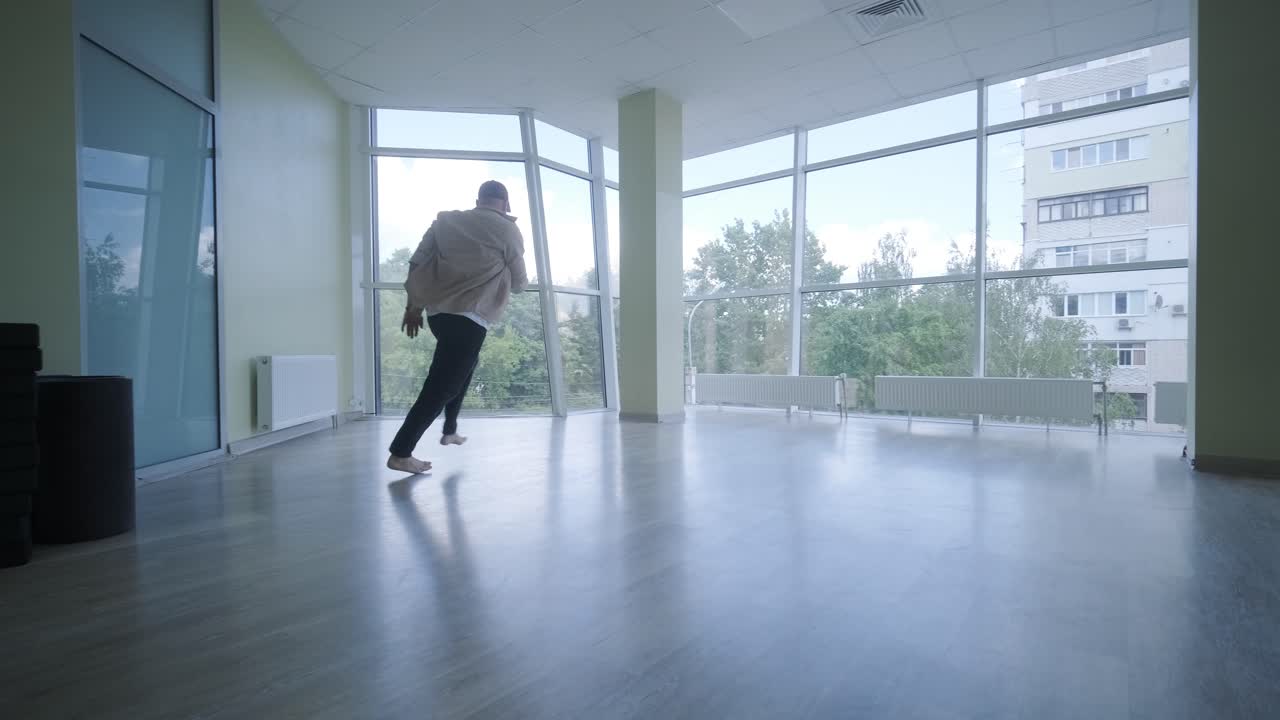 Man Breakdancing in Modern Studio