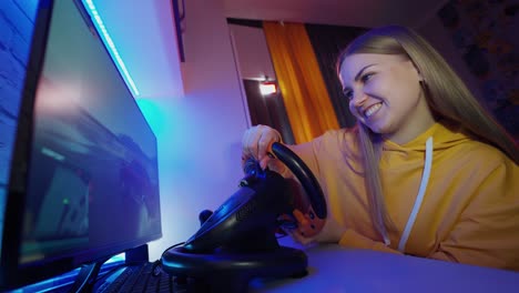 girl playing in car simulator. young female student playing games at home