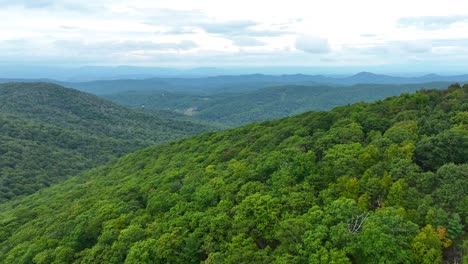 aerial flyover green cole mountain in virginia during cloudy day, usa