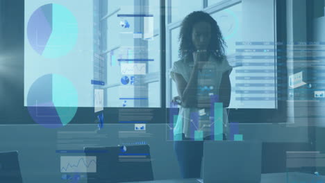animation of financial data processing over african american businesswoman using laptop in office