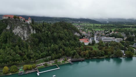 bled castle slovenia drone aerial view panning shot low cloud on distant mountains