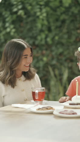 wide shot clip with panning showing a boy celebrating his birthday with his family.