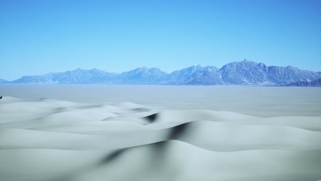 stunning desert landscape with rolling sand dunes and distant mountains