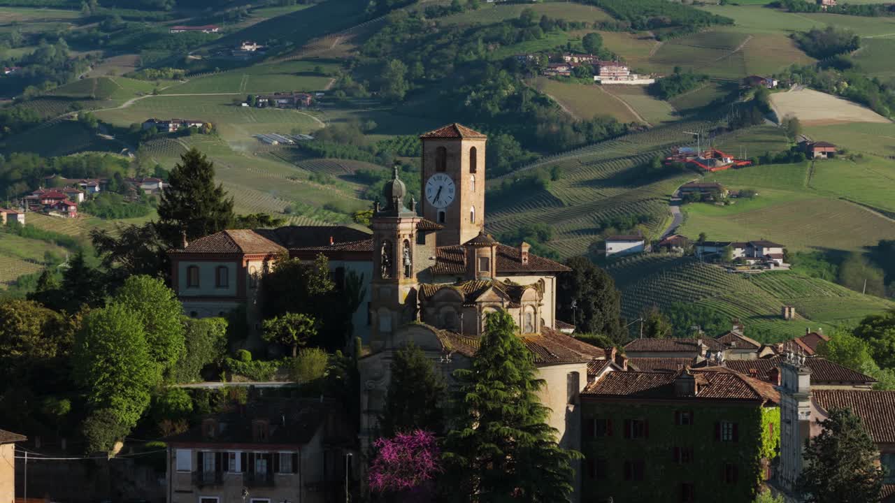 Historic hilltop town of Neive with prominent bell tower, surrounded by rolling hills in Piedmont region, Italy, Picturesque Italian village, Italy. Aerial drone lateral view