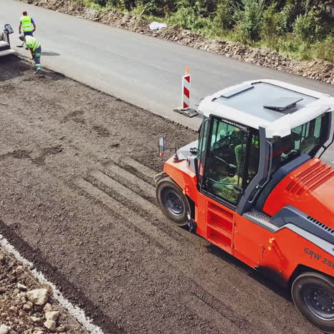 heavy asphalt roller that stack and press hot asphalt. road repair machine. repairing in modern city with vibration roller compactor. aerial view.