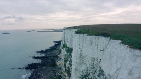 low drone shot along muddy pathways on top of white cliffs of dover