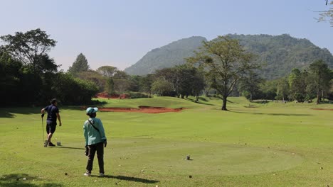golfer executing a swing on a clear day