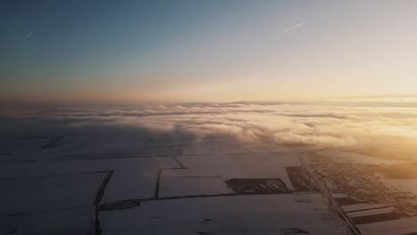 Aerial-shot-of-sunrise-clouds-with-land-at-the-bottom