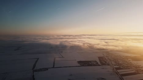 aerial shot of sunrise clouds with land at the bottom