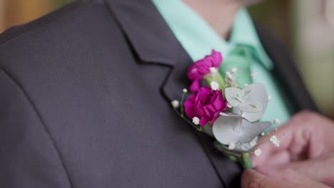 groom with boutonniere in his wedding suit