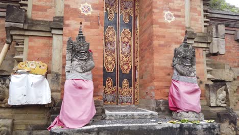 balinese temple architecture facade ornaments with golden details doors, statues and ancient traditional style of bali hindu, indonesia