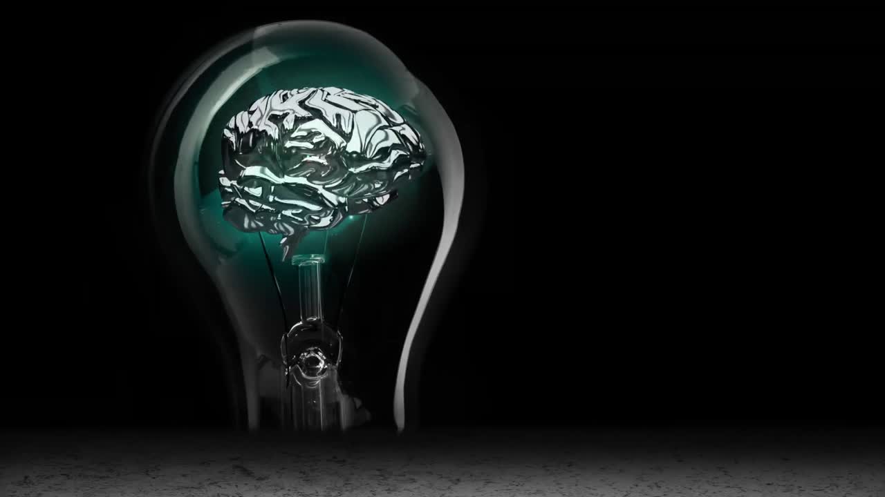 Animation of light bulb with human brain and copy space on black background