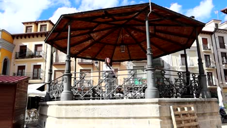 woman on bandstand in city center of aranda de duero, spain