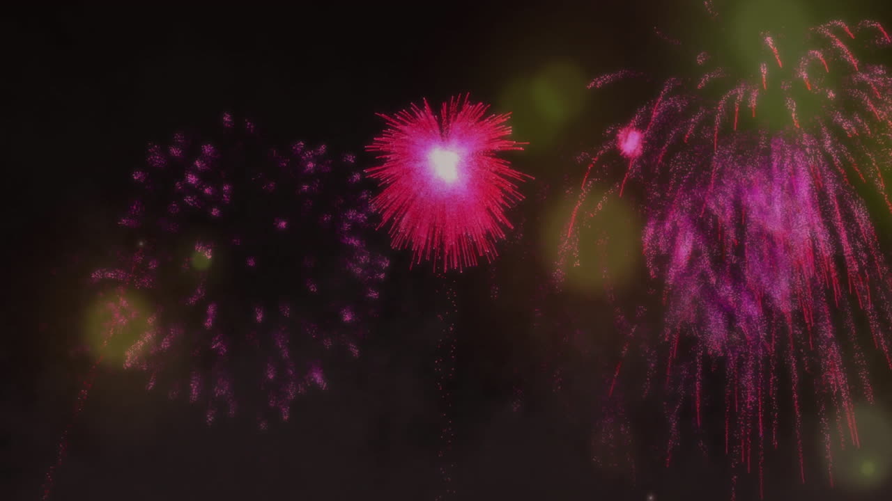 Pink fireworks animation over dark background with glowing lights