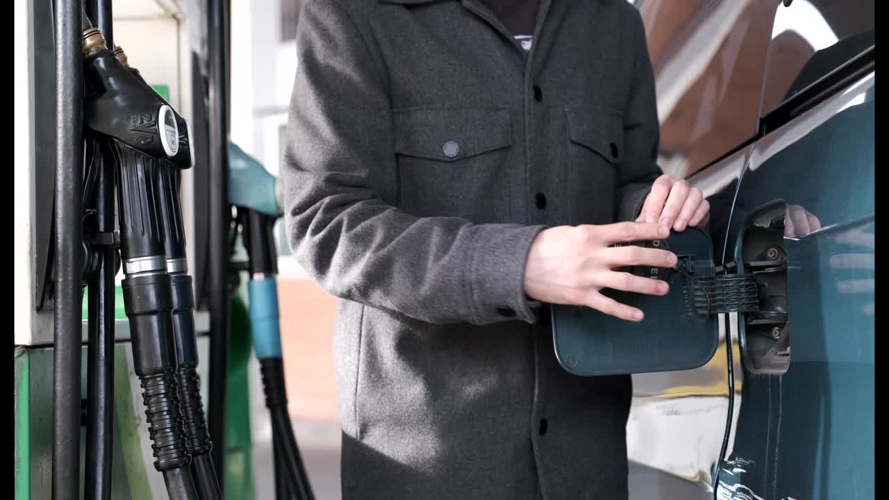 부인할 수 없는 남자가 주유소에서 차량 크에 디젤을 채우고 있습니다.