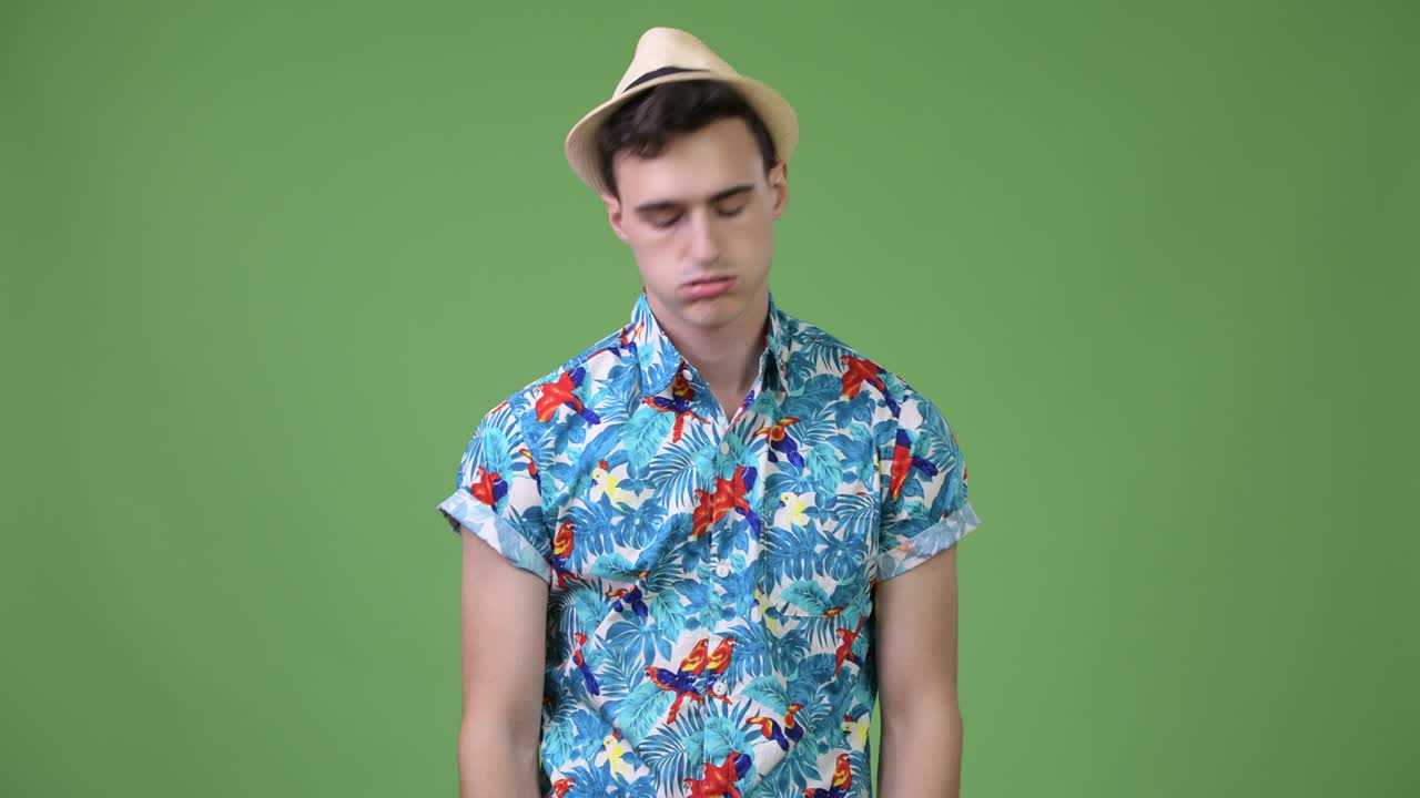 Young handsome tourist man looking bored