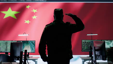 Chinese-military-officer-in-uniform-monitors-critical-data-on-big-screen