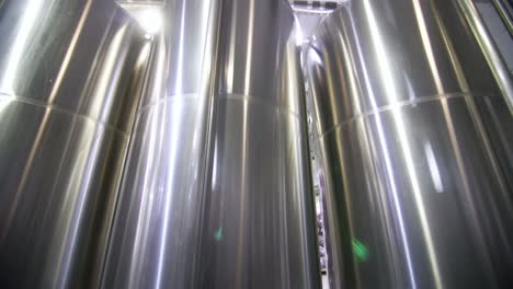 stainless steel cylindrical tanks in industrial setting
