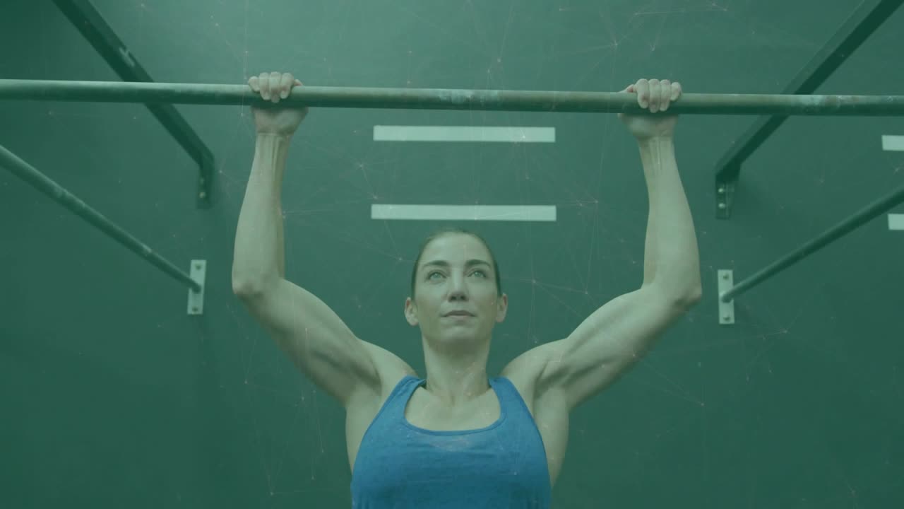 Female athlete initiating descent by extending elbows, lowering body on fitness rig, chalk rising