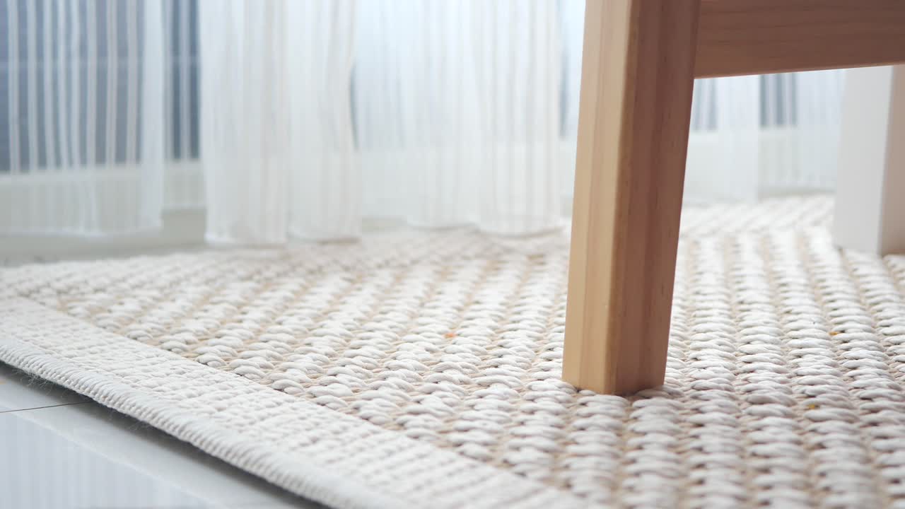 Close up of a rug and chair leg