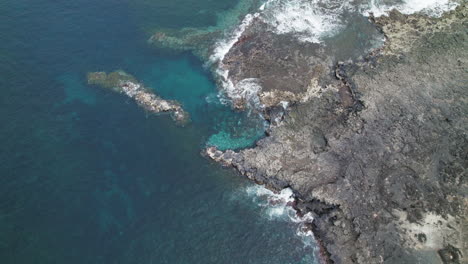 Drone-topshot-over-the-coast-of-Lanzarote,-volcanic-rocks