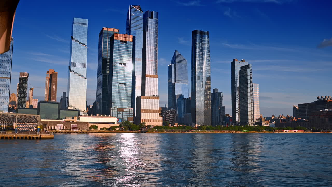 Modern stylish high-rise buildings in the skyline of New York, USA. Low angle view on the city from the riverscape