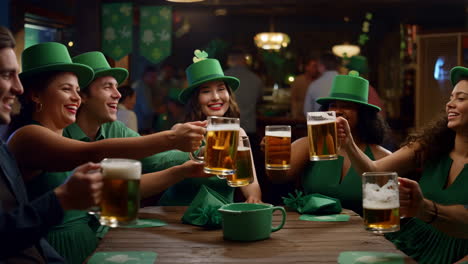 friends celebrating st. patrick's day with a beer toast in a pub