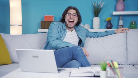 cheerful young man watching video with funny content.