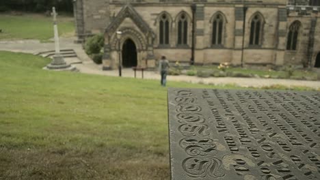 Woman-strolls-through-churchyard