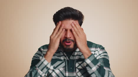 bearded indian man loses becoming surprised by lottery results bad fortune loss unlucky news