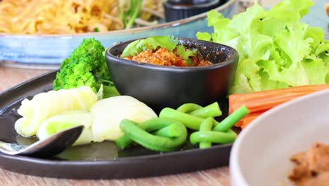 assembling a thai chili dip with vegetables