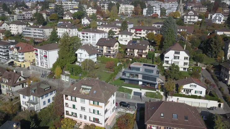 Drone panoramic: Lausanne, residential neighborhood in the town, trees and houses, urban environment, Switzerland, Vaud, aerial view, sloping building plot