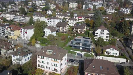 drone panoramic: lausanne, residential neighborhood in the town, trees and houses, urban environment, switzerland, vaud, aerial view, sloping building plot