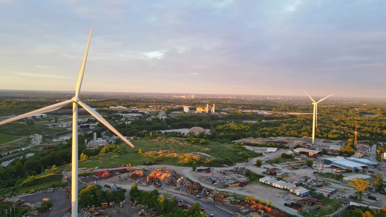 Aerial shot of windmills generating electricity in Rhode Island during a sunset