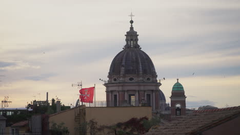 rooftops and dome of the church of san rocco in rome, italy