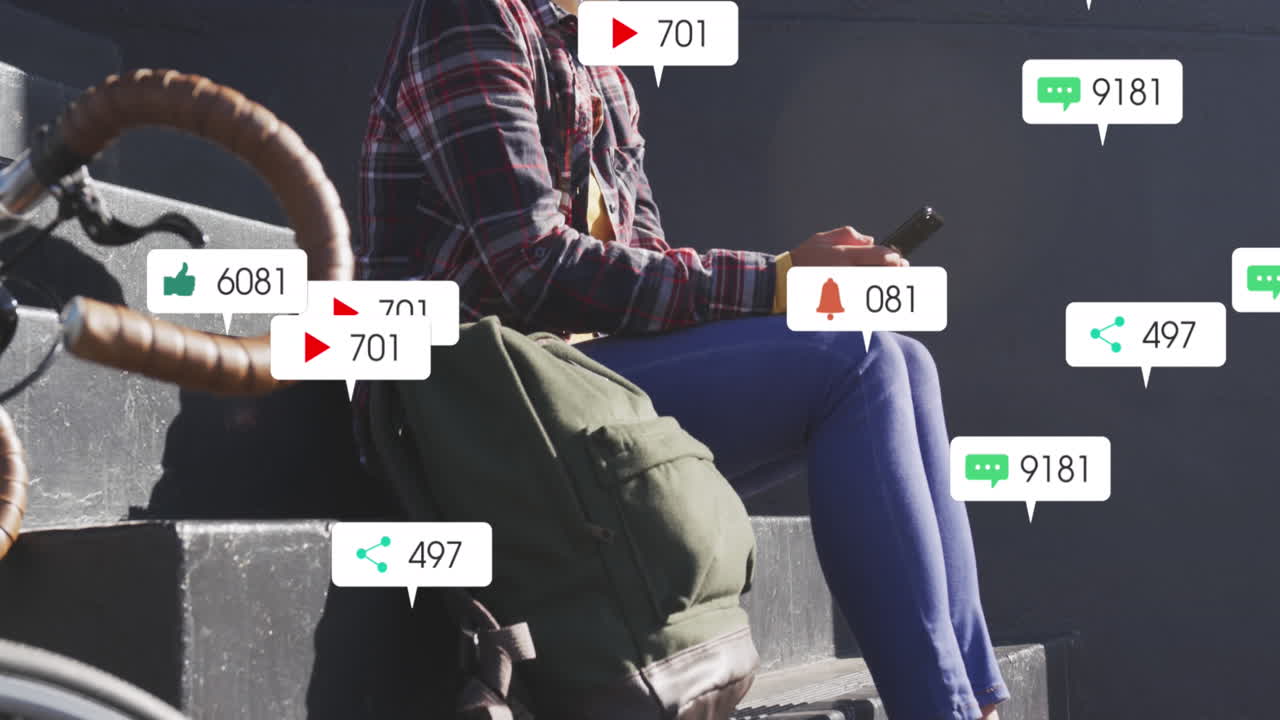 animación de texto e iconos de redes sociales sobre mujer biracial con máscara facial con teléfono inteligente