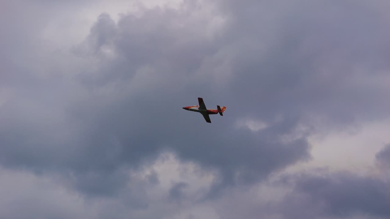 The Patrulla Aguila aerobatic team of the Spanish Air Force. One flies through the cloudy sky at Airpower 2024