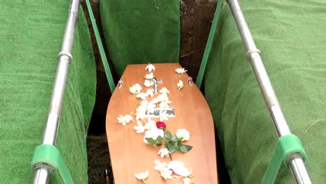 closeup shot of a funeral casket in a hearse or chapel or burial at cemetery