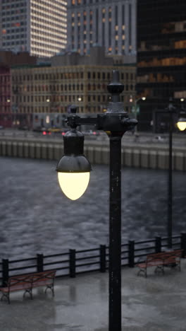 a street lamp illuminates a city street at night