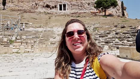 happy tourist selfie at the ancient theatre of dionysus, athens, greece