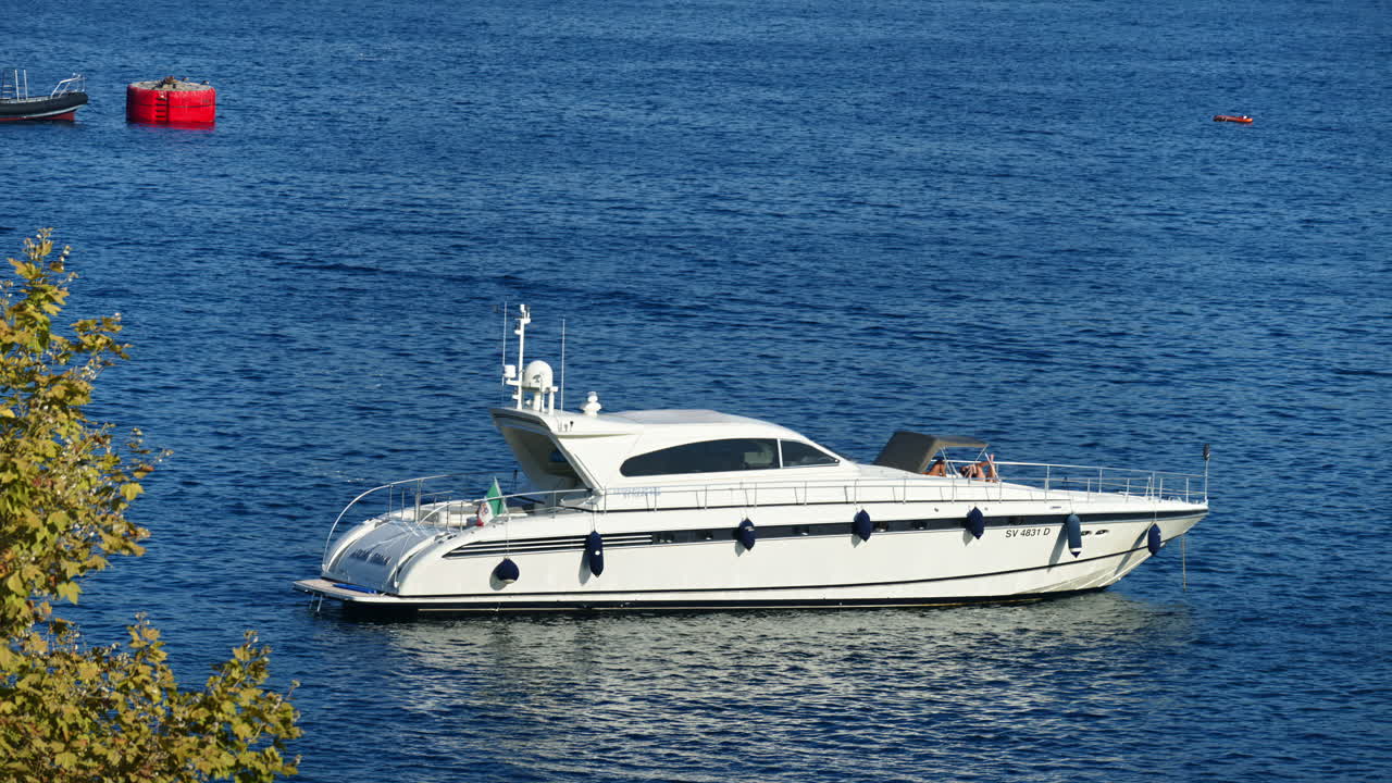 White boat docked in the harbour in Villefranche-sur-Mer, France