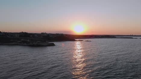 Aerial-footage-of-sunset-above-the-port-Lozenets-,-Bulgaria,-filmed-by-drone-flying-down-to-the-water