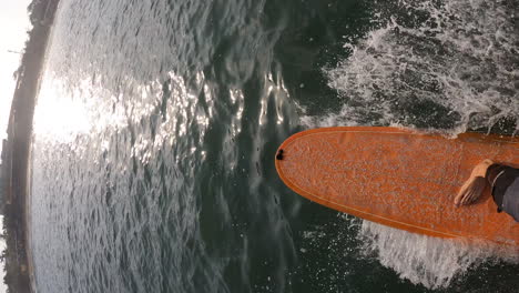 POV-young-athletic-guy-male-surfing-on-a-lonboarding-in-canggu-beach,-Bali,-Indonesia