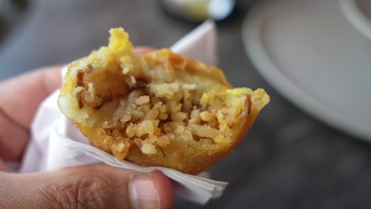 Eating Colombian Stuffed Potatoes. Close Up