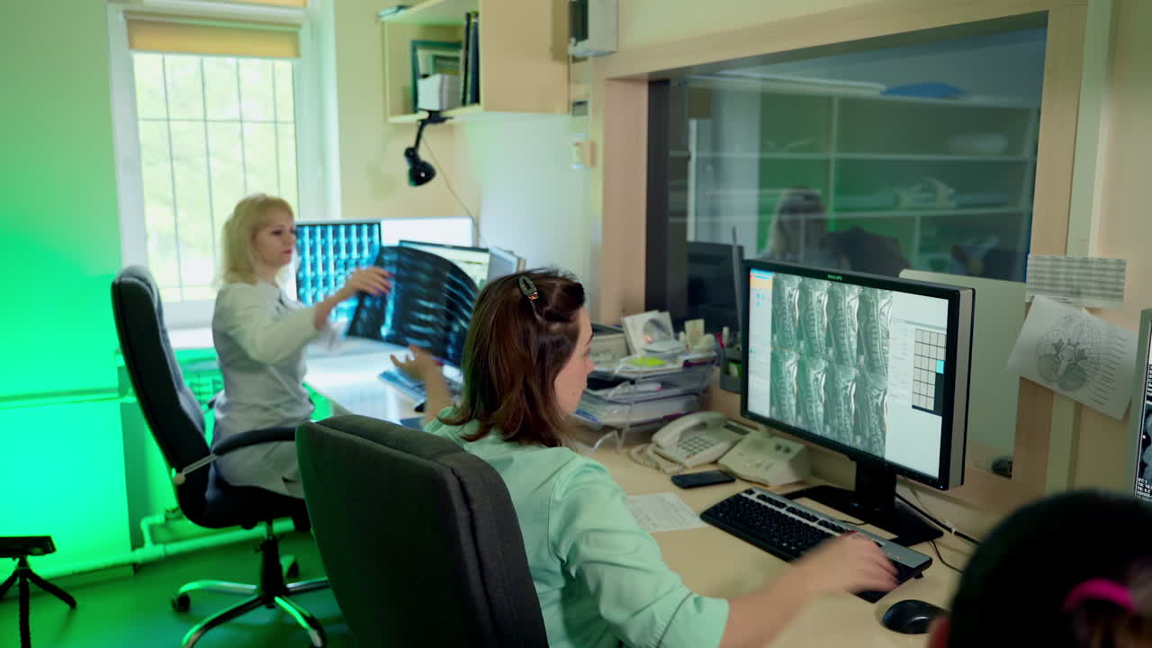 Control office in CT. Doctors checking chest x-ray film at hospital