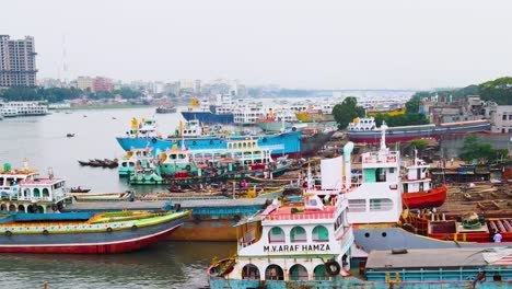 Drone-aerial-shot-of-a-strait-with-ships-and-boats-at-the-dockyard-or-shipyard-for-repair