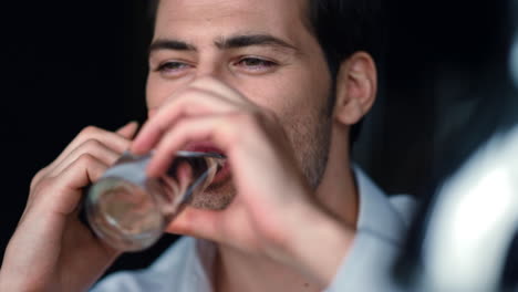 Businessman-face-calling-on-smartphone-at-office.-Man-drinking-water-from-glass