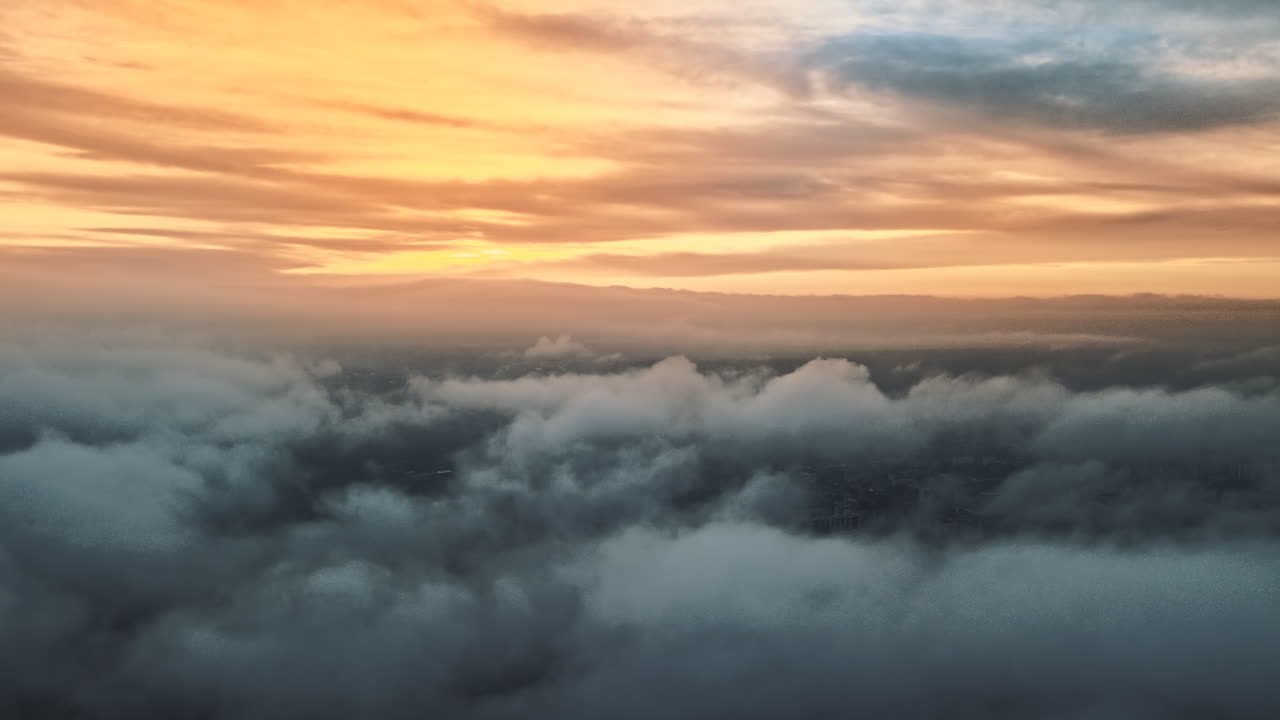 Aerial drone view above the clouds with buildings visible through, Chisinau, Moldova