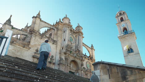 woman climb stairs of cathedral jerez de la frontera - low angle shot